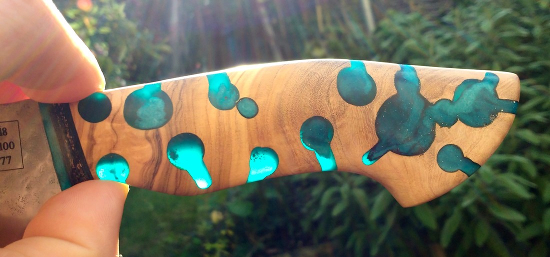 Handmade Santoku handle - olive wood with blue resin infills inspired by the pattern of the bowdrill method of making fire. 