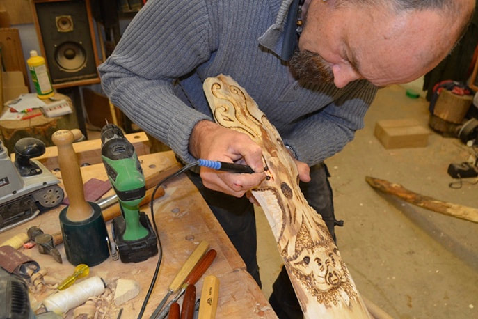 Henk Littlewood of Wooden Henk putting detail on one of his handmade wood projects